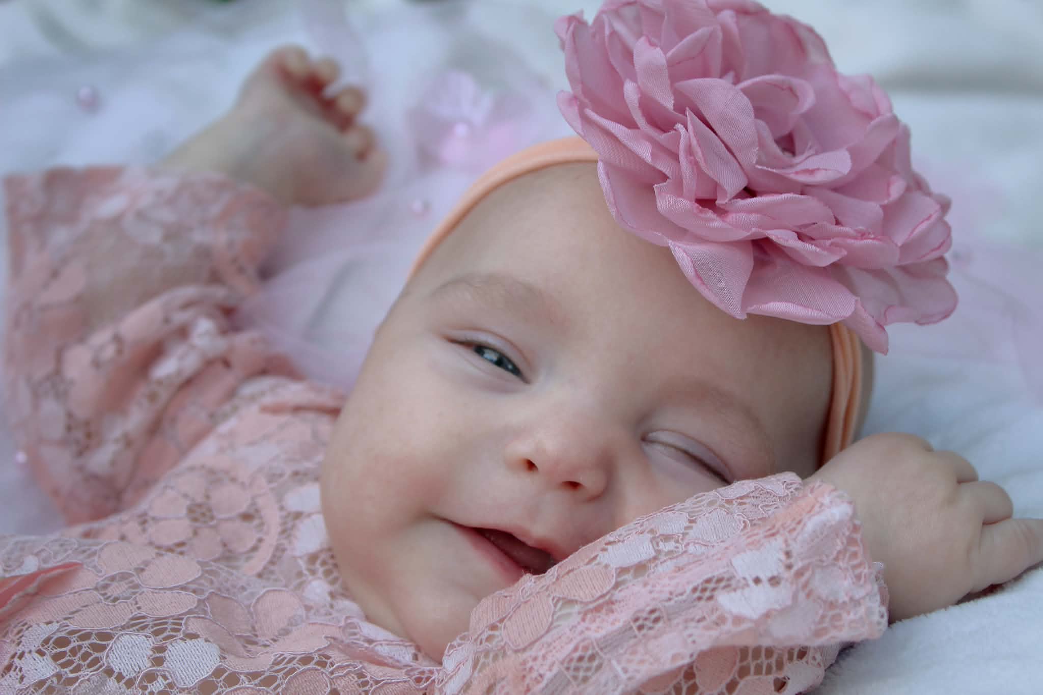 Baby in pink with a flower headband